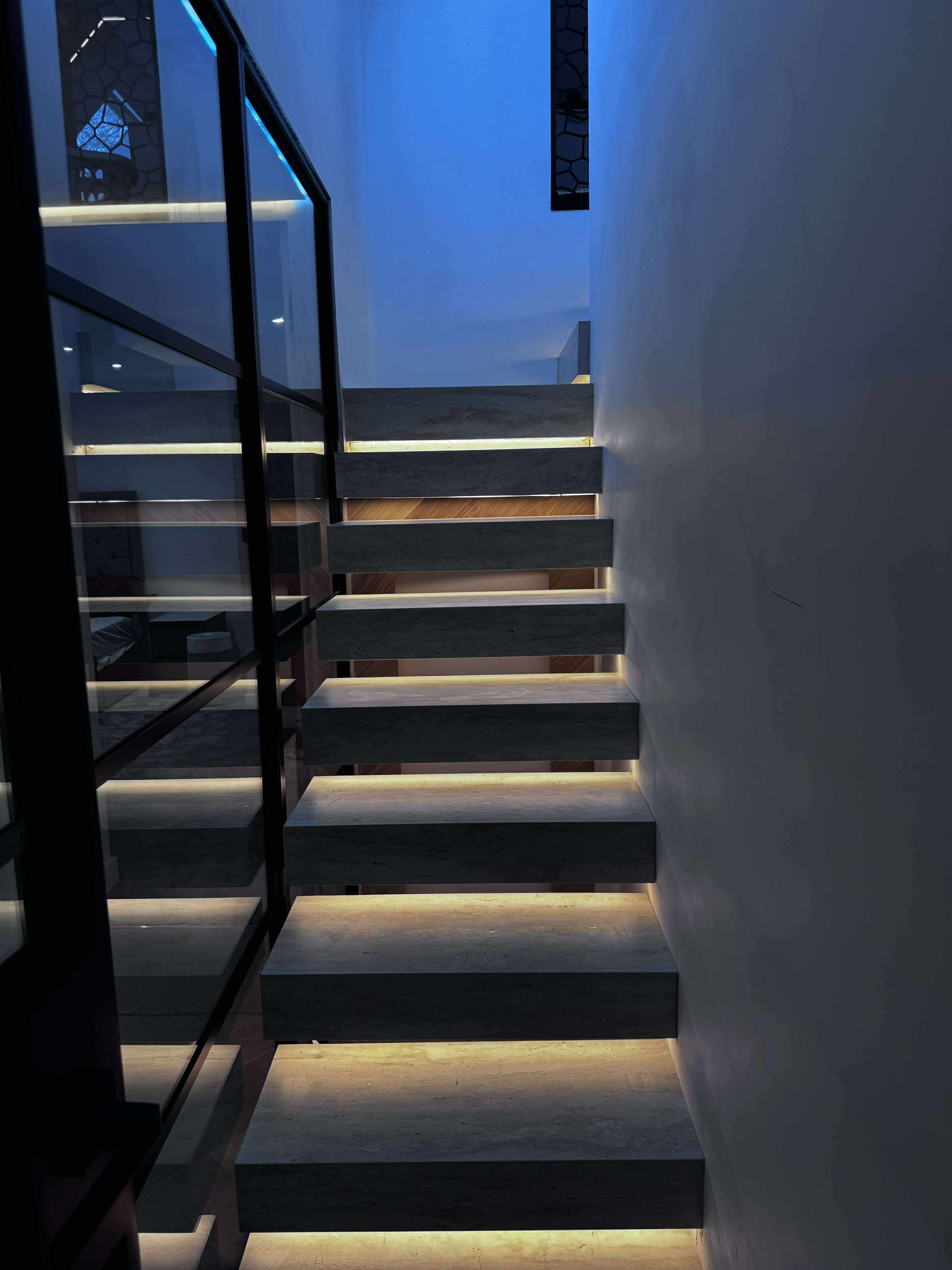 Dark tiled staircase with illuminated steps