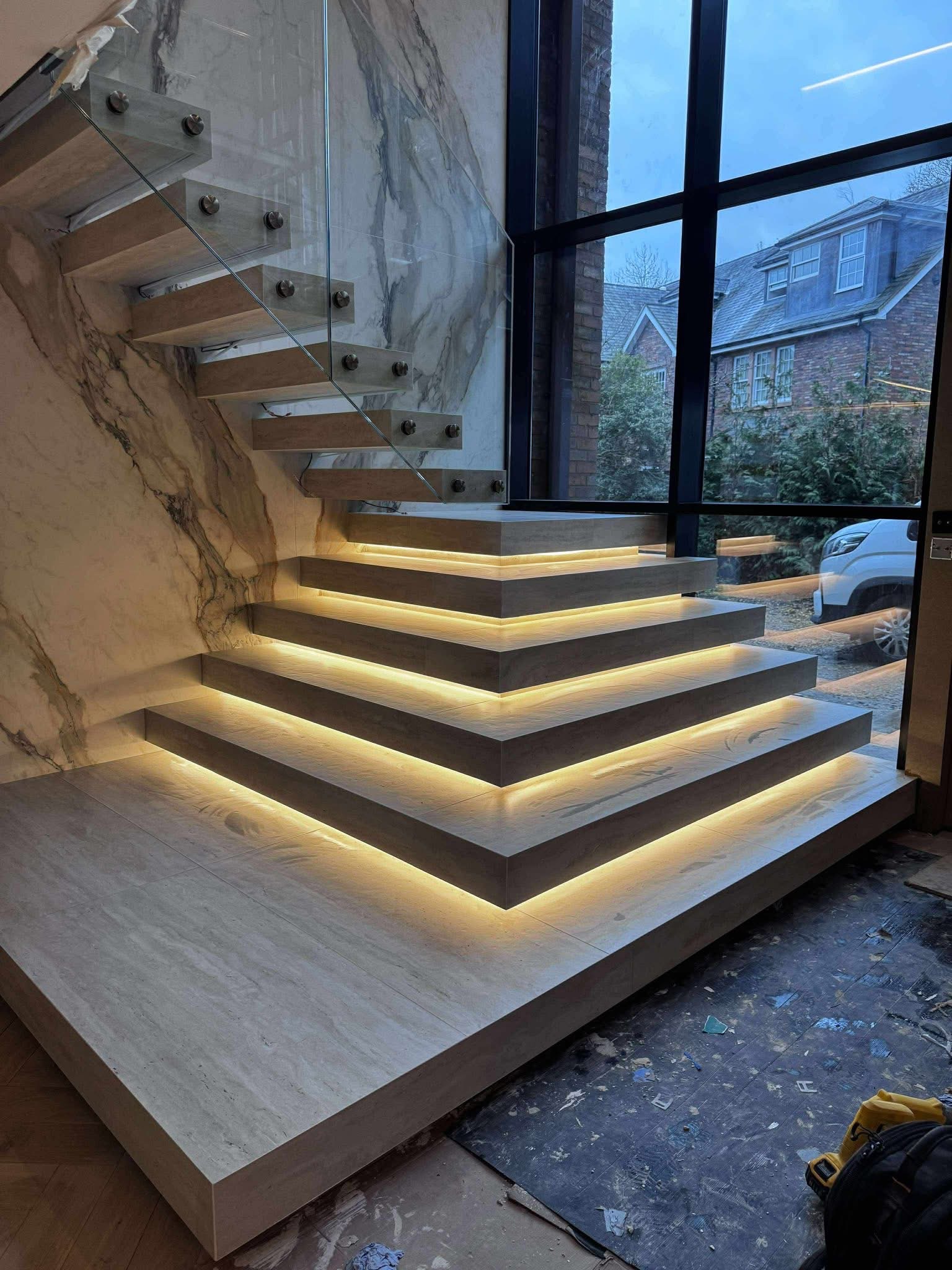 Wide tiled staircase and glass balustrade