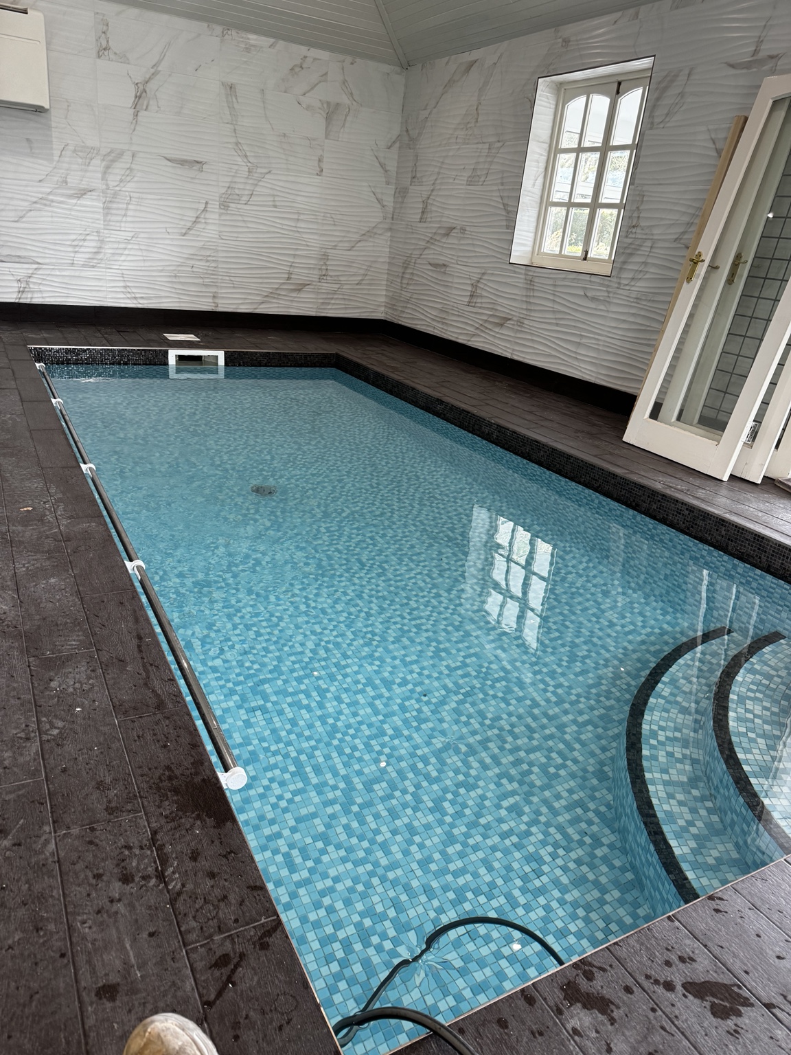 Indoor swimming pool with blue mosaic finish