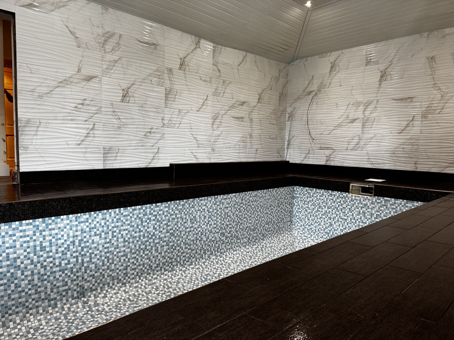 Completed indoor swimming pool with mosaic tiling